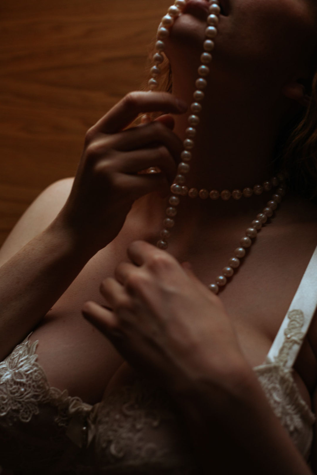 Woman wearing a statement pearl necklace with dark contrasting details