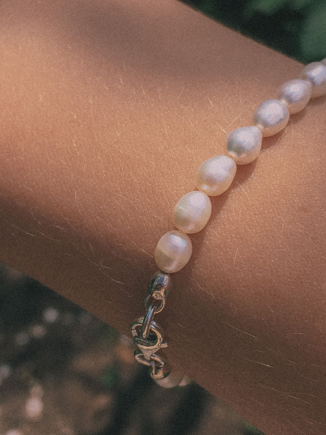 Pearl bracelet worn on the wrist in natural light