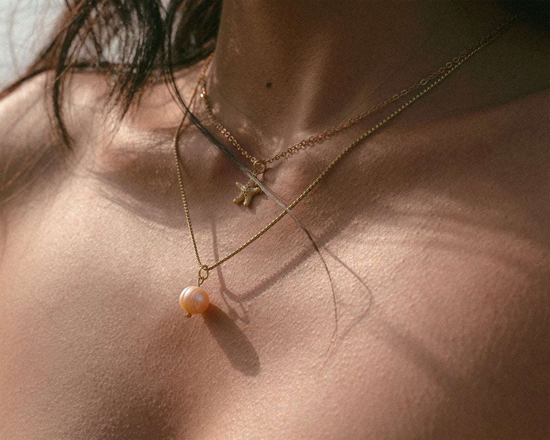 Close-up of a pearl pendant showing jewelry details that influence price